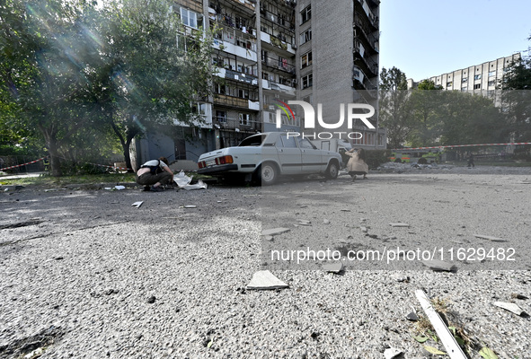 A car parks outside the residential high-rise damaged by Russian shelling in Zaporizhzhia, Ukraine, on October 1, 2024. NO USE RUSSIA. NO US...