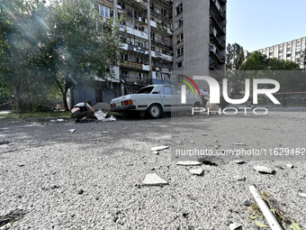 A car parks outside the residential high-rise damaged by Russian shelling in Zaporizhzhia, Ukraine, on October 1, 2024. NO USE RUSSIA. NO US...