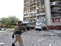 A rescuer passes by the residential high-rise damaged by Russian shelling in Zaporizhzhia, Ukraine, on October 1, 2024. NO USE RUSSIA. NO US...