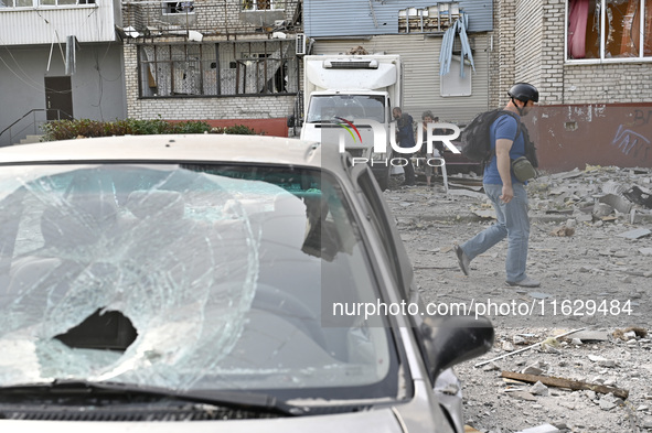 A man passes by the residential high-rise damaged by Russian shelling in Zaporizhzhia, Ukraine, on October 1, 2024. NO USE RUSSIA. NO USE BE...