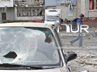 A man passes by the residential high-rise damaged by Russian shelling in Zaporizhzhia, Ukraine, on October 1, 2024. NO USE RUSSIA. NO USE BE...