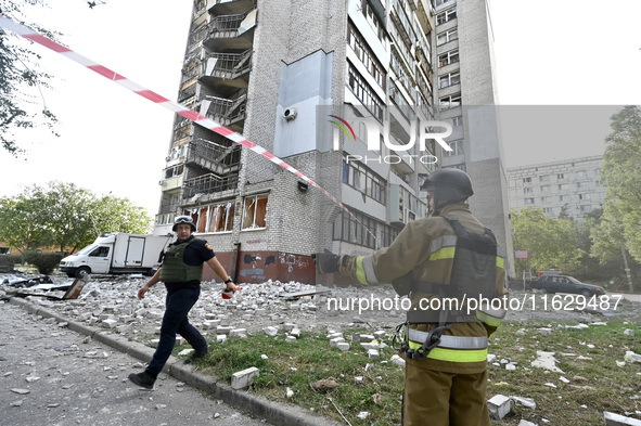 Rescuers are seen outside the residential high-rise damaged by Russian shelling in Zaporizhzhia, Ukraine, on October 1, 2024. NO USE RUSSIA....