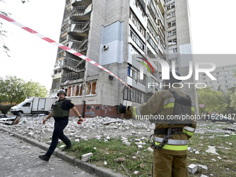 Rescuers are seen outside the residential high-rise damaged by Russian shelling in Zaporizhzhia, Ukraine, on October 1, 2024. NO USE RUSSIA....