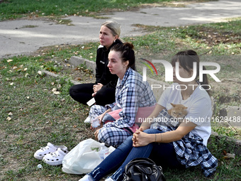 Women affected by Russian shelling are seen with their cat in Zaporizhzhia, Ukraine, on October 1, 2024. NO USE RUSSIA. NO USE BELARUS. (