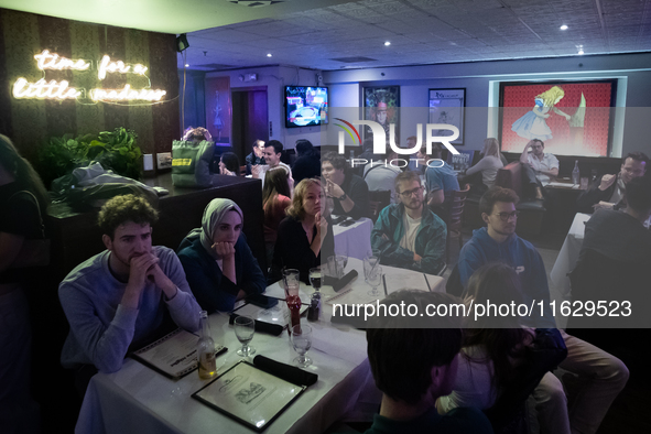 People attend a watch party at Madhatter for the Vice presidential debate between Demcocrat Gov. Tim Walz (D-MN) and Republican Sen. J.D. Va...