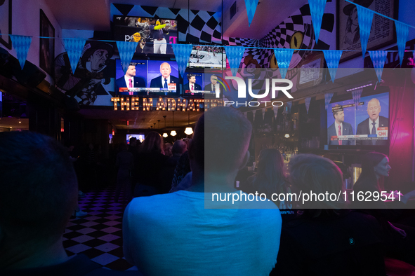 People attend a watch party at Madhatter for the Vice presidential debate between Demcocrat Gov. Tim Walz (D-MN) and Republican Sen. J.D. Va...