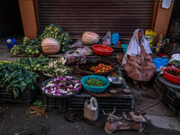 An elderly woman sells vegetables and waits for customers on a roadside in Baramulla, Jammu and Kashmir, India, on October 2, 2024. (