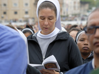 A nun attends The Holy Mass led by Pope Francis for the opening session of the 16th Ordinary General Assembly of the Synod of Bishops in Vat...