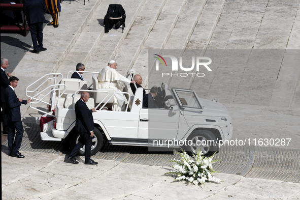 Pope Francis greets the crowd at the end of a mass for the opening of the Ordinary General Assembly of the Synod of Bishops in The Vatican,...