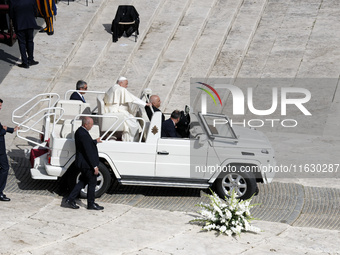 Pope Francis greets the crowd at the end of a mass for the opening of the Ordinary General Assembly of the Synod of Bishops in The Vatican,...