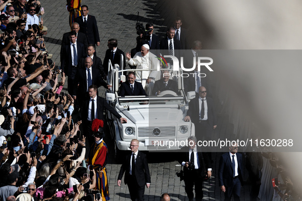 Pope Francis greets the crowd at the end of a mass for the opening of the Ordinary General Assembly of the Synod of Bishops in The Vatican,...