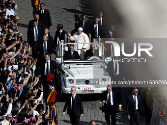 Pope Francis greets the crowd at the end of a mass for the opening of the Ordinary General Assembly of the Synod of Bishops in The Vatican,...