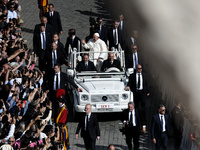 Pope Francis greets the crowd at the end of a mass for the opening of the Ordinary General Assembly of the Synod of Bishops in The Vatican,...