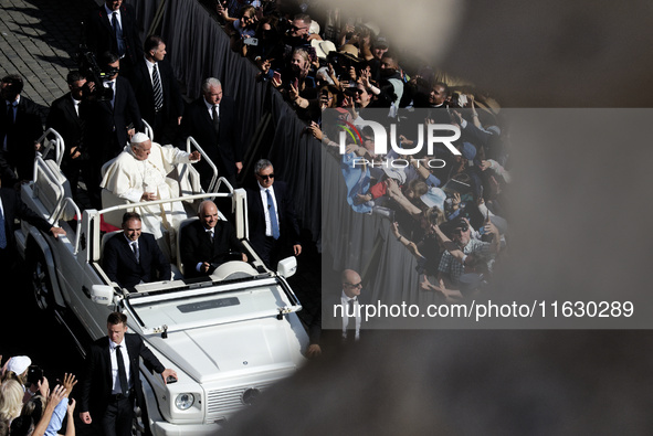 Pope Francis greets the crowd at the end of a mass for the opening of the Ordinary General Assembly of the Synod of Bishops in The Vatican,...