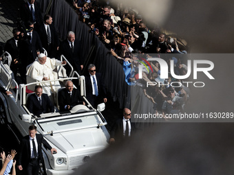 Pope Francis greets the crowd at the end of a mass for the opening of the Ordinary General Assembly of the Synod of Bishops in The Vatican,...