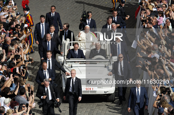 Pope Francis greets the crowd at the end of a mass for the opening of the Ordinary General Assembly of the Synod of Bishops in The Vatican,...