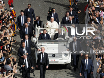 Pope Francis greets the crowd at the end of a mass for the opening of the Ordinary General Assembly of the Synod of Bishops in The Vatican,...