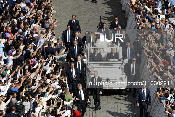 Pope Francis greets the crowd at the end of a mass for the opening of the Ordinary General Assembly of the Synod of Bishops in The Vatican,...