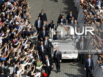 Pope Francis greets the crowd at the end of a mass for the opening of the Ordinary General Assembly of the Synod of Bishops in The Vatican,...