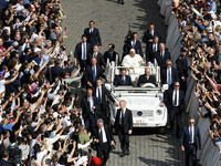 Pope Francis greets the crowd at the end of a mass for the opening of the Ordinary General Assembly of the Synod of Bishops in The Vatican,...