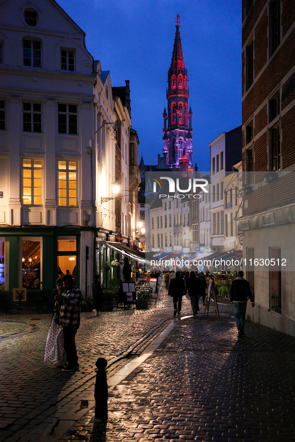 People walk on a street next to the Grand Place in Brussels, Belgium, on September 27, 2024. 