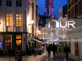 People walk on a street next to the Grand Place in Brussels, Belgium, on September 27, 2024. (