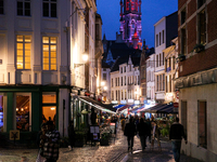 People walk on a street next to the Grand Place in Brussels, Belgium, on September 27, 2024. (