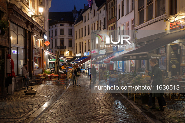 People walk on a street next to the Grand Place in Brussels, Belgium, on September 27, 2024. 