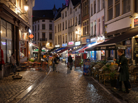 People walk on a street next to the Grand Place in Brussels, Belgium, on September 27, 2024. (