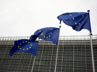 EU flags wave outside the European Commission building in Brussels, Belgium, on September 30, 2024. (