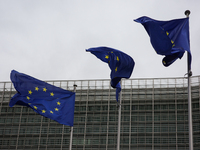 EU flags wave outside the European Commission building in Brussels, Belgium, on September 30, 2024. (