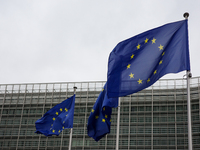 EU flags wave outside the European Commission building in Brussels, Belgium, on September 30, 2024. (