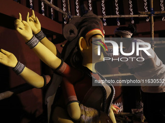 An artisan, Upshona Chatterjee, prepares idols of the Hindu goddess Durga during the auspicious day of Mahalay in a ''pandal'' or temporary...