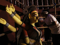 An artisan, Upshona Chatterjee, prepares idols of the Hindu goddess Durga during the auspicious day of Mahalay in a ''pandal'' or temporary...