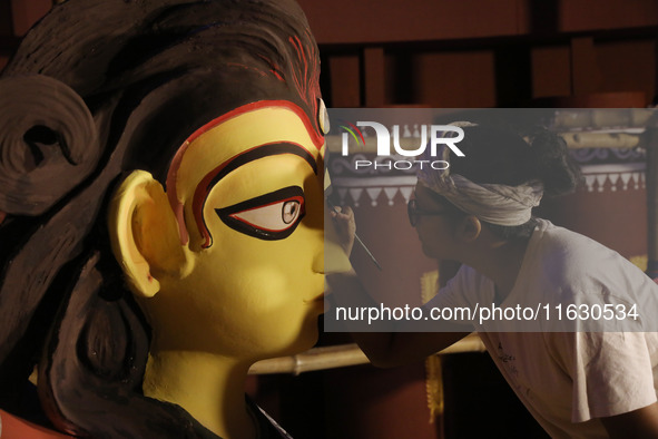 An artisan, Upshona Chatterjee, prepares idols of the Hindu goddess Durga during the auspicious day of Mahalay in a ''pandal'' or temporary...