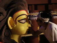 An artisan, Upshona Chatterjee, prepares idols of the Hindu goddess Durga during the auspicious day of Mahalay in a ''pandal'' or temporary...