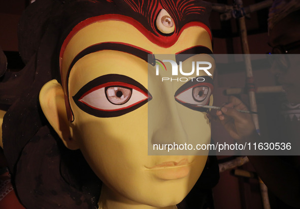 An artisan, Upshona Chatterjee, prepares idols of the Hindu goddess Durga during the auspicious day of Mahalay in a ''pandal'' or temporary...