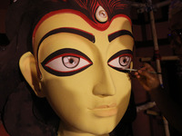 An artisan, Upshona Chatterjee, prepares idols of the Hindu goddess Durga during the auspicious day of Mahalay in a ''pandal'' or temporary...