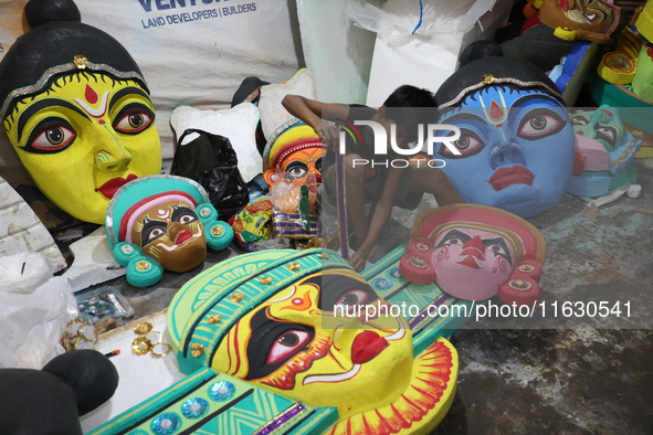 An artisan prepares decoration items to be used for decorating a 'pandal' or temporary platform at a workshop ahead of the Durga Puja festiv...