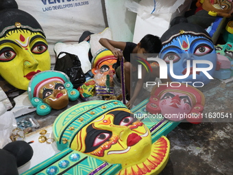 An artisan prepares decoration items to be used for decorating a 'pandal' or temporary platform at a workshop ahead of the Durga Puja festiv...