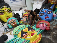 An artisan prepares decoration items to be used for decorating a 'pandal' or temporary platform at a workshop ahead of the Durga Puja festiv...