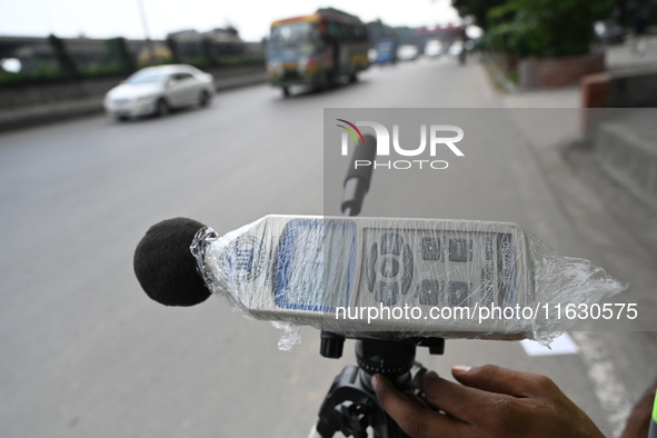 A volunteer checks the sound level meter on the street to measure noise levels during the No Horn campaign at Airport Road in Dhaka, Banglad...