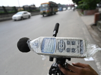 A volunteer checks the sound level meter on the street to measure noise levels during the No Horn campaign at Airport Road in Dhaka, Banglad...