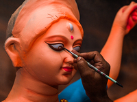 Artisans work on finishing touches of Goddess Durga idols at a workshop in the potter's colony of Tehatta, West Bengal, India, on October 2,...