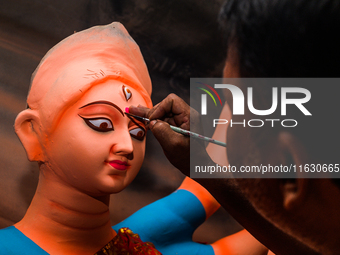 Artisans work on finishing touches of Goddess Durga idols at a workshop in the potter's colony of Tehatta, West Bengal, India, on October 2,...