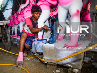 Artisans work on finishing touches of Goddess Durga idols at a workshop in the potter's colony of Tehatta, West Bengal, India, on October 2,...