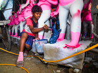 Artisans work on finishing touches of Goddess Durga idols at a workshop in the potter's colony of Tehatta, West Bengal, India, on October 2,...