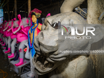 Artisans work on finishing touches of Goddess Durga idols at a workshop in the potter's colony of Tehatta, West Bengal, India, on October 2,...