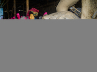 Artisans work on finishing touches of Goddess Durga idols at a workshop in the potter's colony of Tehatta, West Bengal, India, on October 2,...