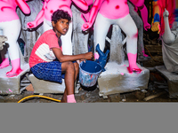 Artisans work on finishing touches of Goddess Durga idols at a workshop in the potter's colony of Tehatta, West Bengal, India, on October 2,...